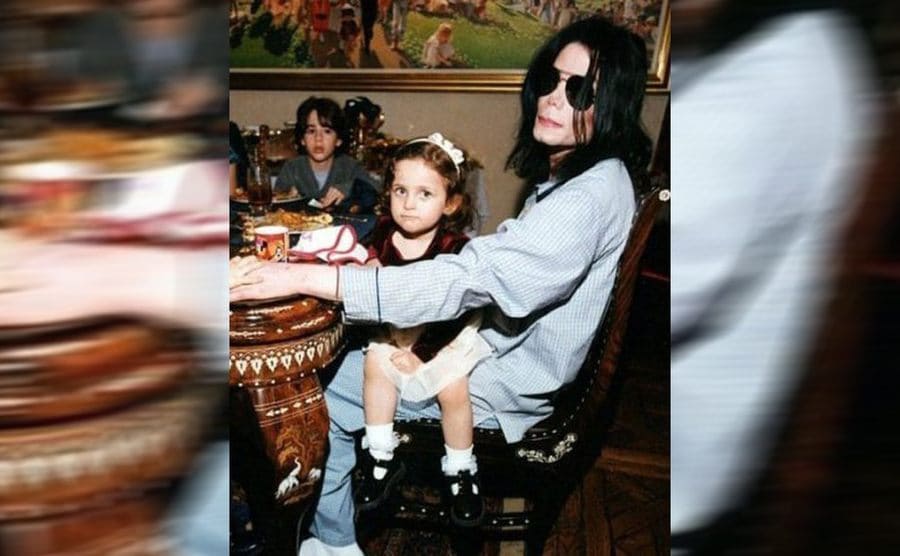 A young Paris Jackson sitting on Michael Jackson’s lap 