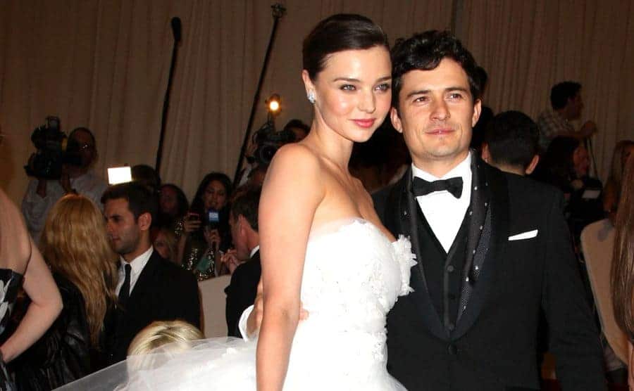 Miranda Kerr and Orlando Bloom posing together on the red carpet 