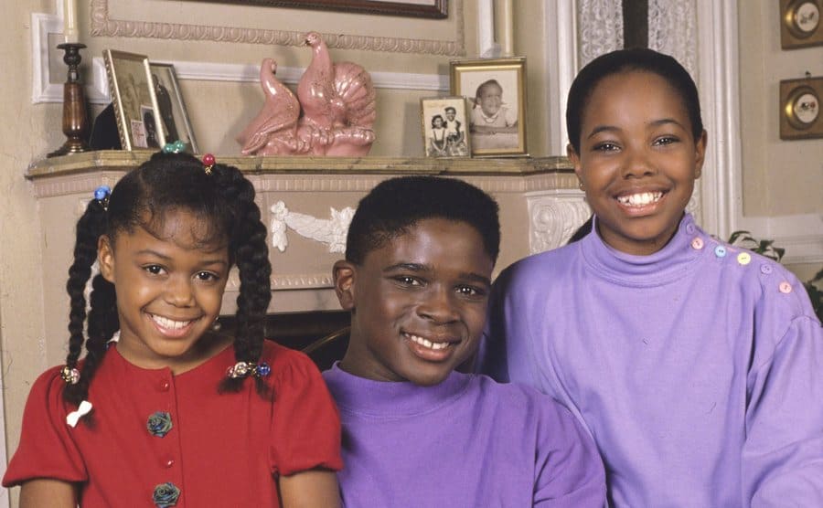 Jaimee Foxworth, Darius McCrary, and Kellie Shanygne Williams posing together on an armchair in Family Matters 