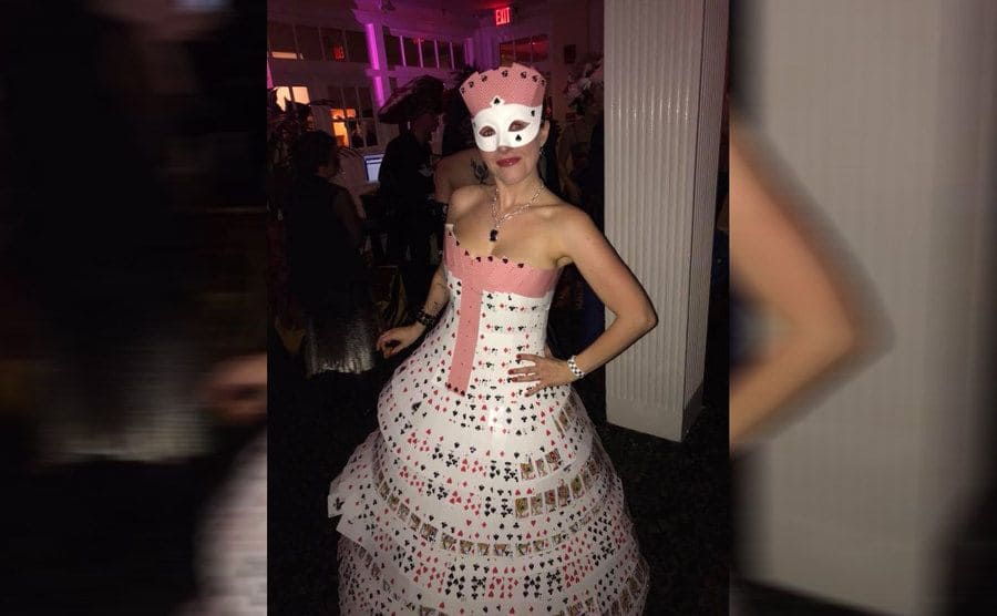 A woman wearing a strapless dress made out of playing cards 