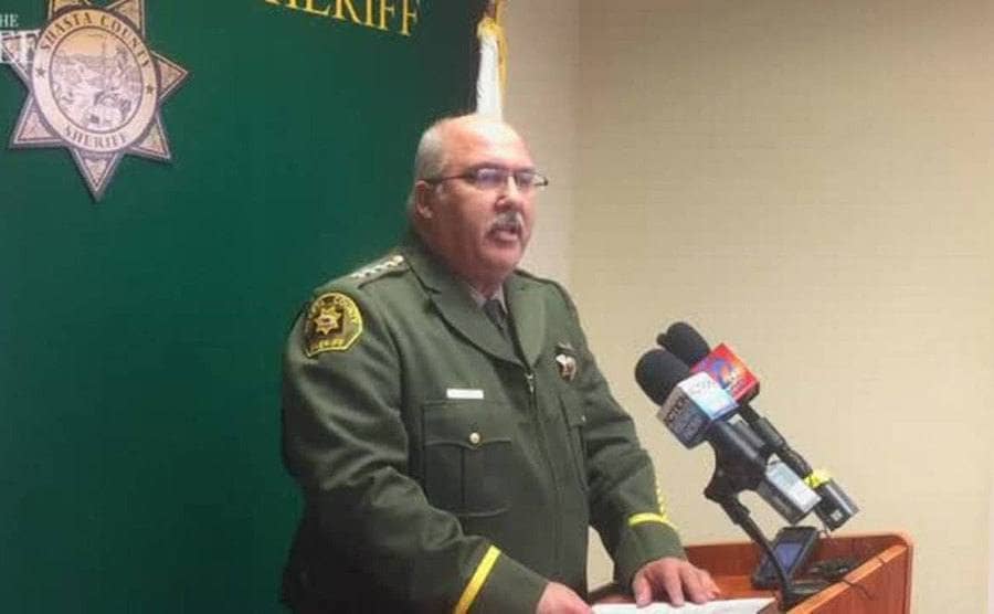 Sheriff Bosenko speaking in front of microphones