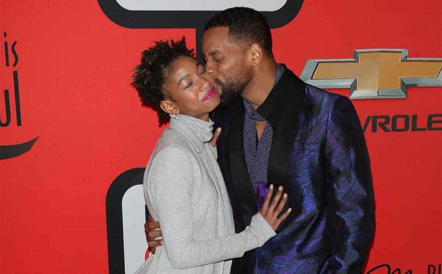 Will Smith giving Willow a kiss on the cheek on the red carpet in 2015