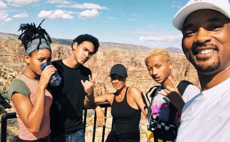Jada and Will with their kids on a hike 