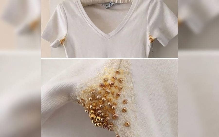 A women's shirt with yellow beading