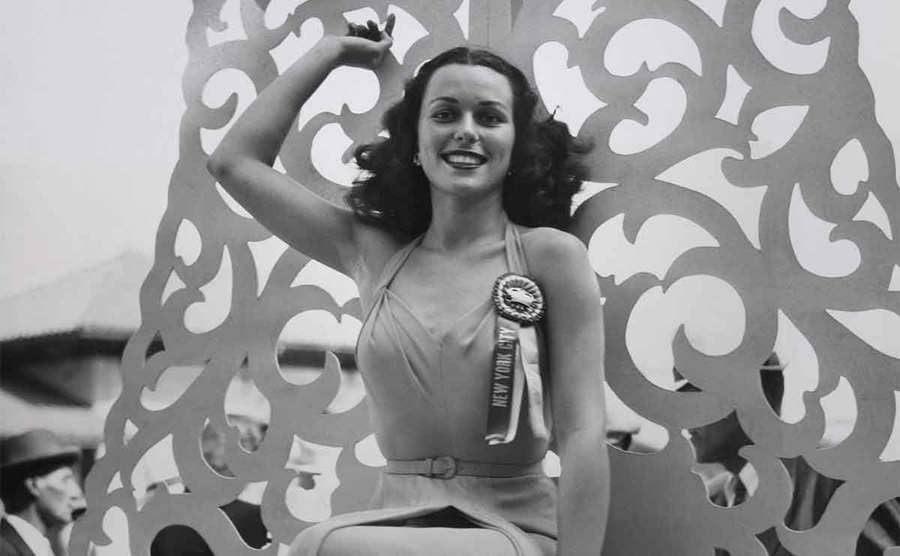Bess Myerson posing with a ribbon attached to her dress 