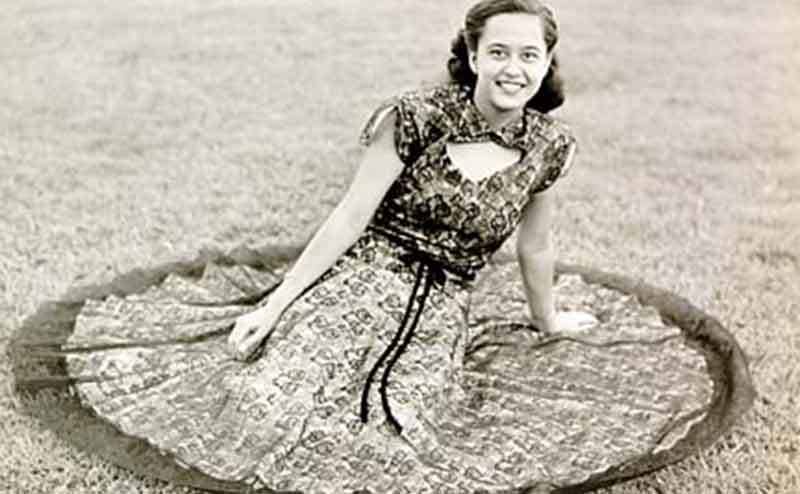 Yun Tau Zane Chee posing on a grassy patch with her skirt surrounding her 