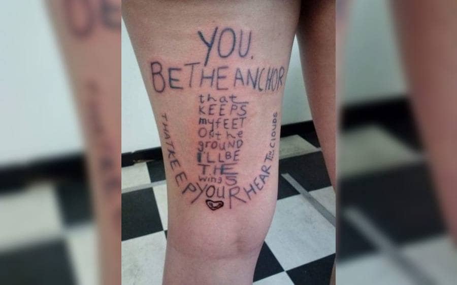 A tattoo on a foot that reads, 