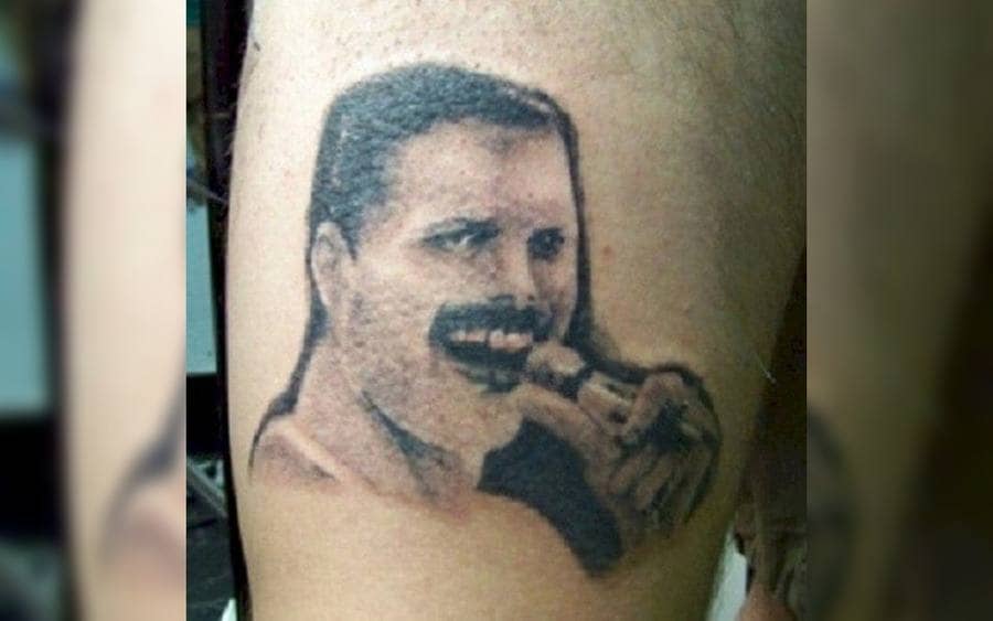 A tattoo of Freddie Mercury on a guy's arm