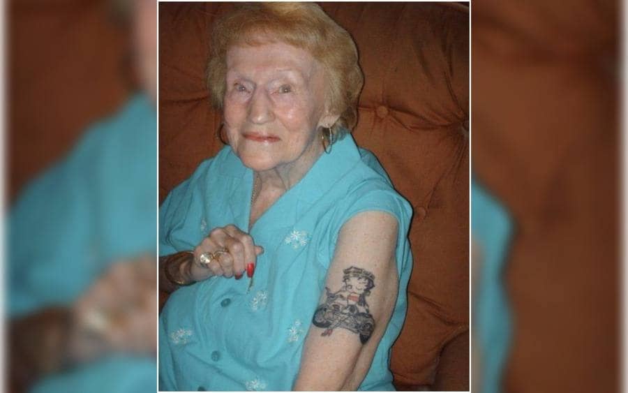 A tattoo of Betty Boop on an old women's arm