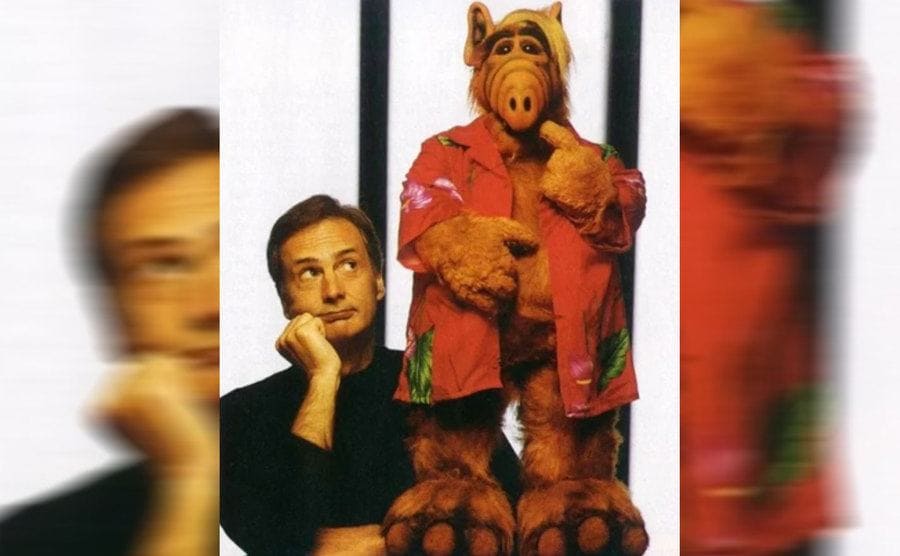 Paul Fusco posing next to the puppet Alf