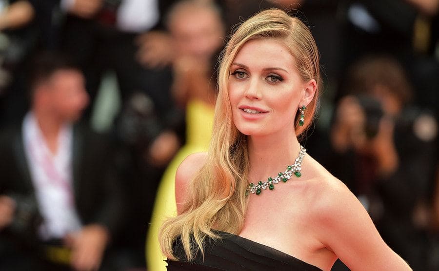 Lady Kitty Spencer wearing a strapless black dress with silver and emerald jewelry