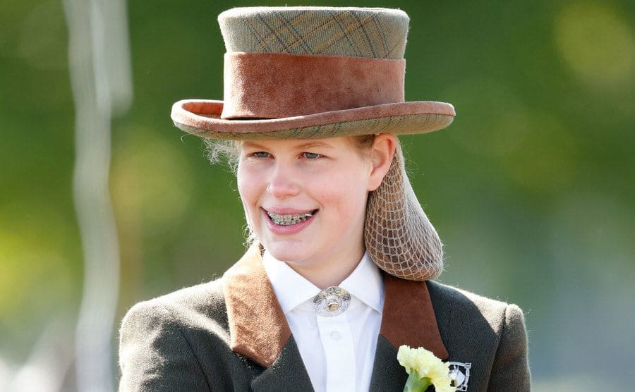 Lady Louise Windsor at a horse show wearing a riding outfit with a hair net 