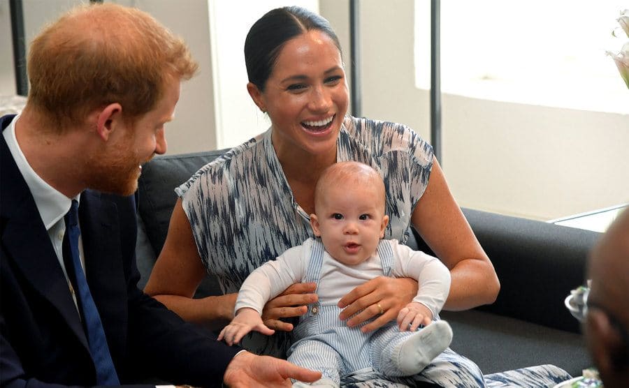 Prince Harry and Meghan Markle with their baby Archie Mountbatten-Windsor making a cute face towards the camera 