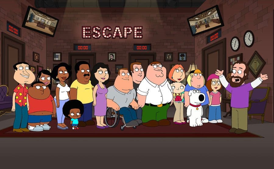 The cast of Family Guy in an escape room having the rules explained to them in a scene from Family Guy 