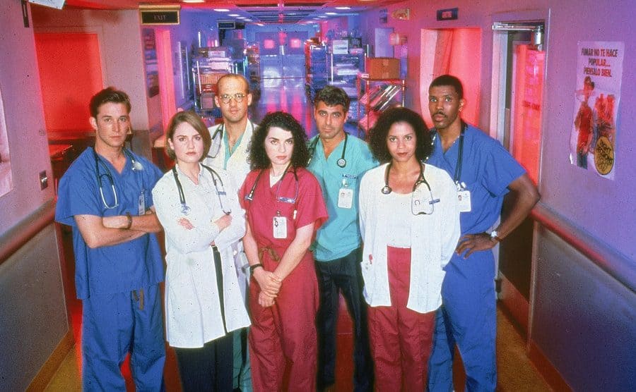The cast of ER standing in the hospital hallway 