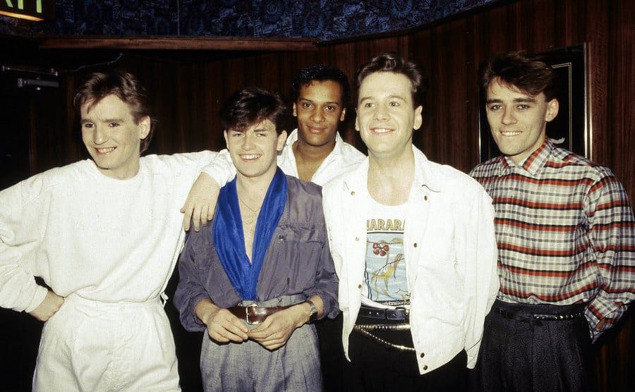 The band Simple Minds posing backstage 