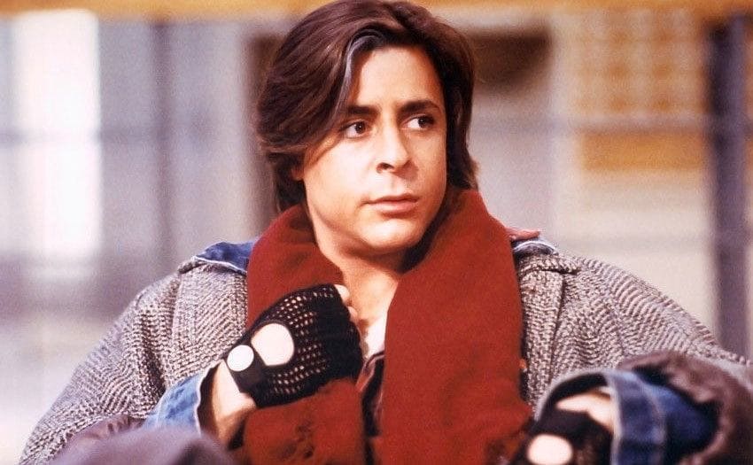 Judd Nelson sitting in the library in a scene from The Breakfast Club 