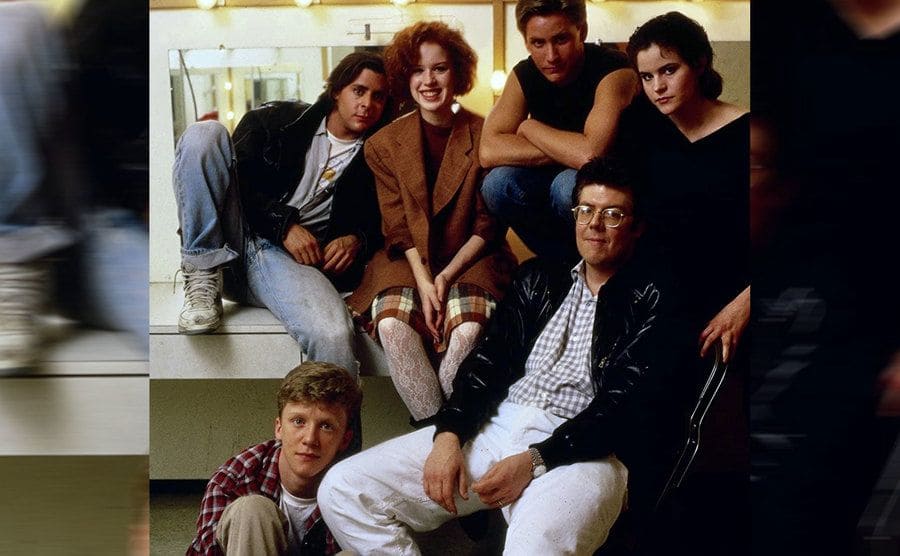 The cast of the Breakfast Club and director John Hughes hanging around back stage