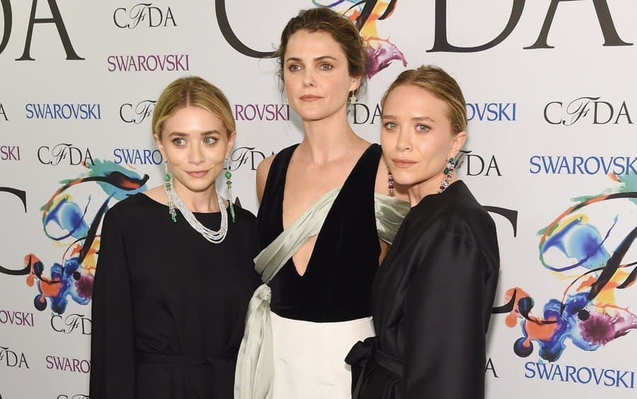 Accessories designer of the year award recipients Mary-Kate Olsen and Ashley Olsen of The Row pose with Keri Russell