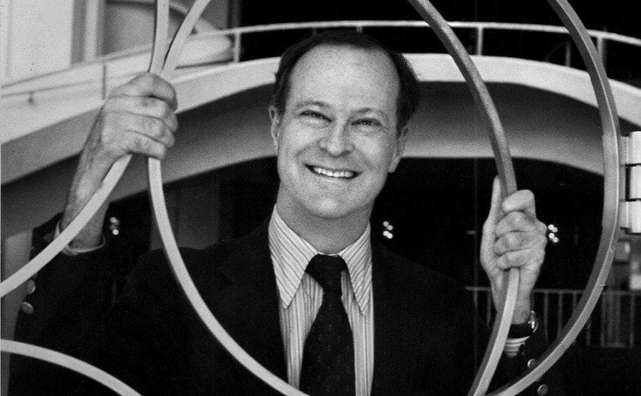 Fred Koch standing in front of a circular metal gate 