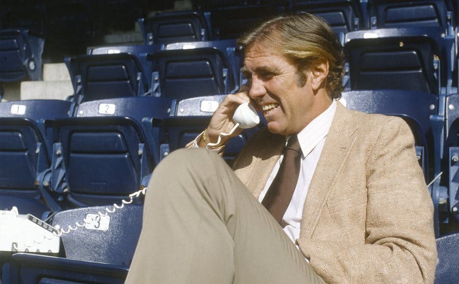 Tim Mara posing on the telephone in the NY Giants stadium chairs
