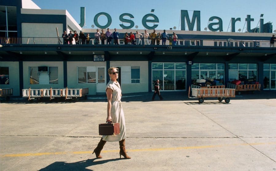 Margaux Hemingway walking on the runway at the airport 