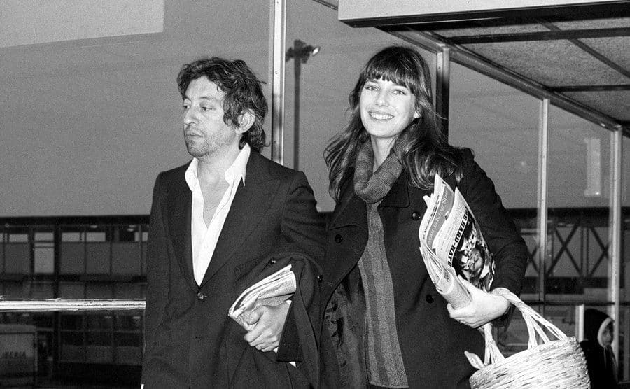 Jane Birkin and Serge Gainsbourg at Heathrow Airport holding hands 