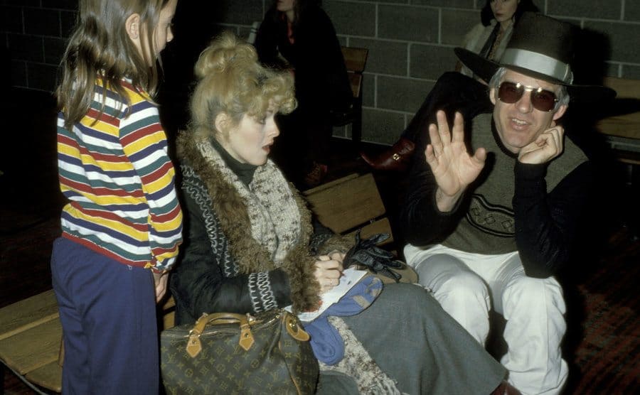 Steve Martin talking to Bernadette Peters at the airport 