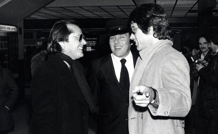 Jack Nicholson and Warren Beaty having a conversation at the airport 