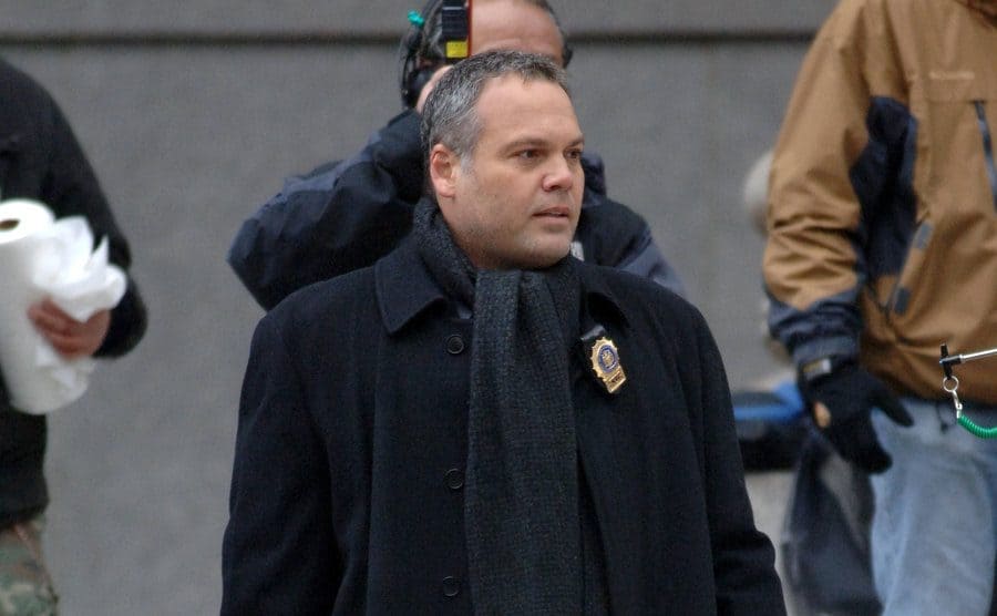 Vincent D’Onofrio as Robert Goren walking down steps of a courthouse 