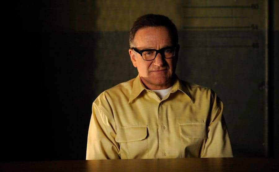 Robin Williams sitting in the interrogation room in a scene from Law and Order 