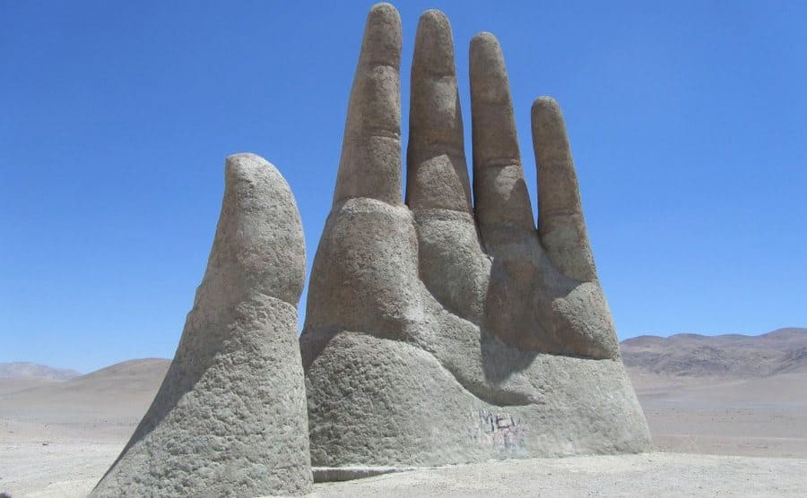 The hand sticking out of the middle of the desert 