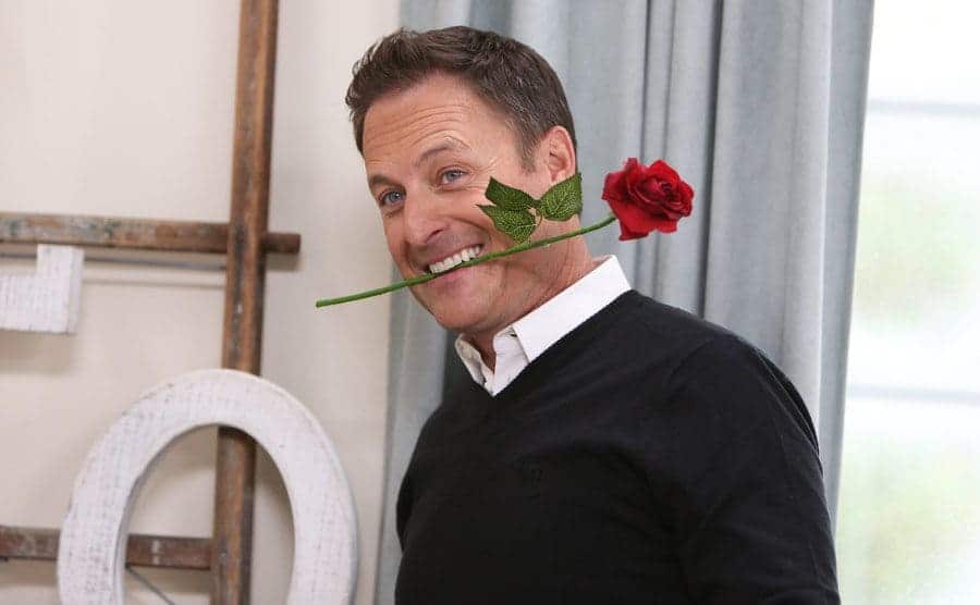 Chris Harrison holding a rose in his mouth 