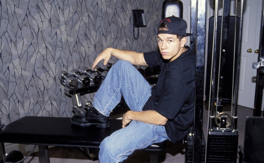 Mark Wahlberg posing on gym equipment 