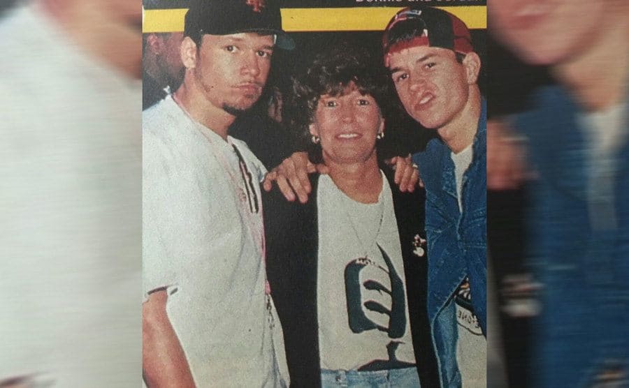 Donnie and Mark Wahlberg posing with their mother on the red carpet 