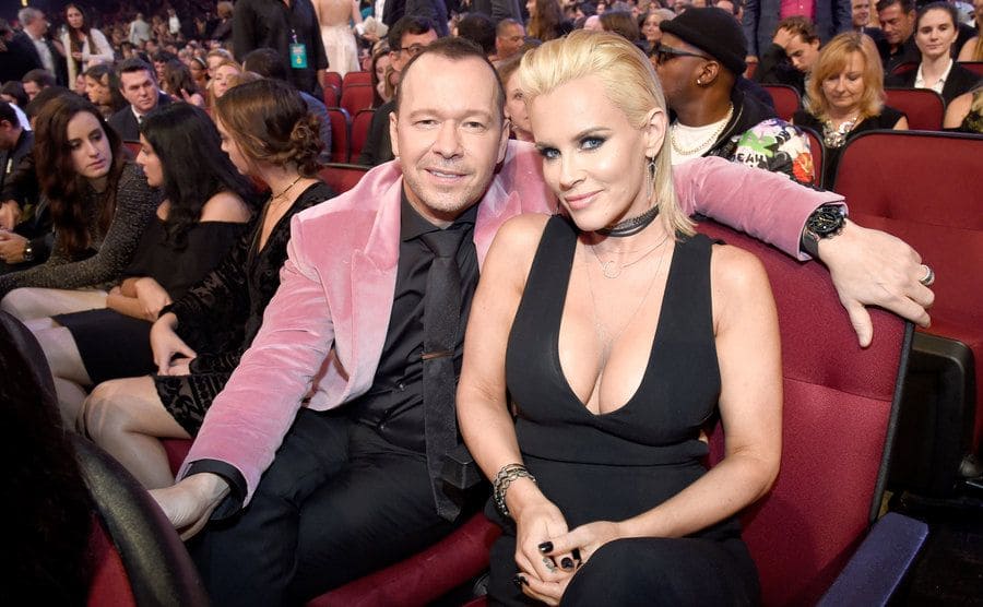Donnie Wahlberg and Jenny McCarthy sitting in a theater at an awards show in 2016
