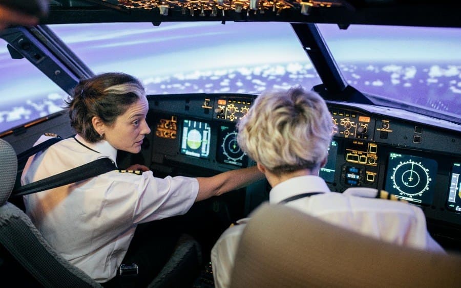 Flight Instructor Describing Dials And Displays To Trainee Pilot