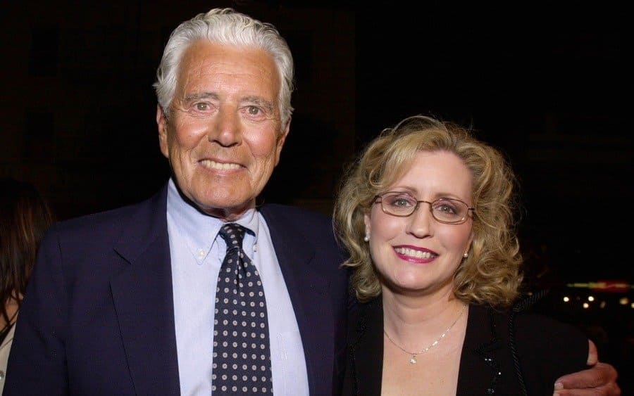 Actor John Forsythe and date arrive at the premiere of Columbia Pictures 