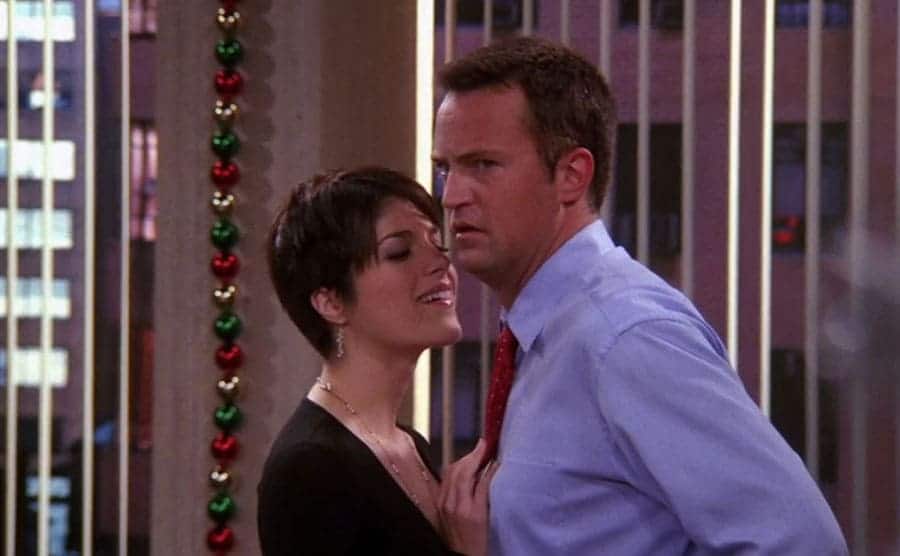 Selma Blair hitting on Matthew Perry in an office in a scene from Friends 