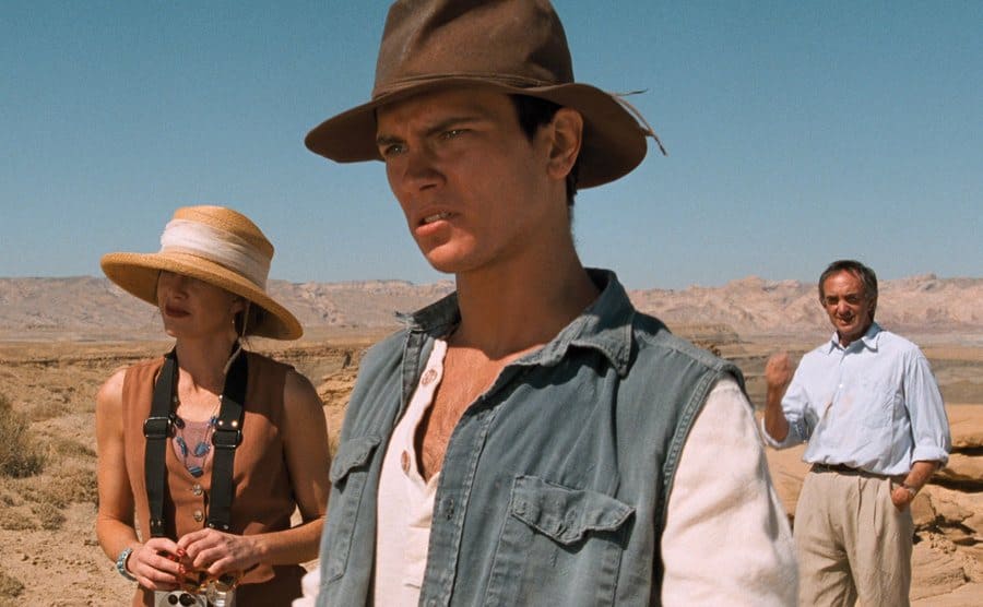 River Phoenix with a woman and man standing in a desert 