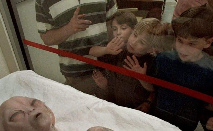 Little kids looking at an alien model on display inside the museum in Roswell