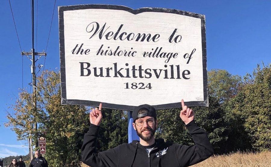 Another tourist is taking a picture in front of Burkittsville.