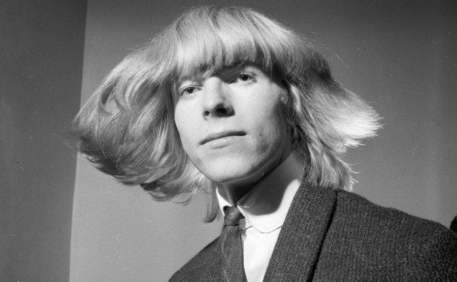 David Bowie circa 1965 shaking his long hair 