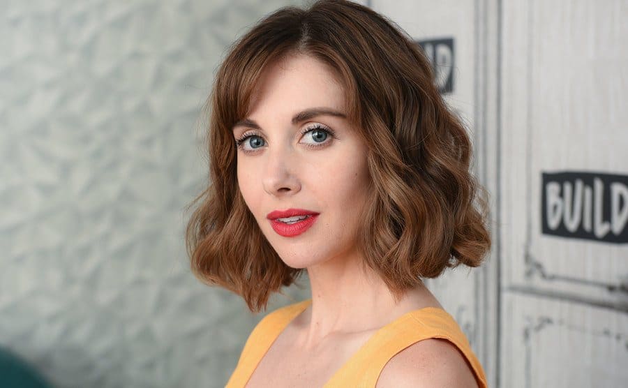 Alison Brie posing on the red carpet 