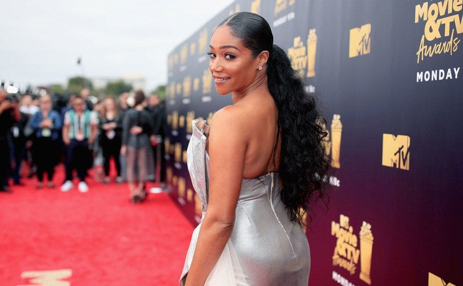 Tiffany Haddish looking over her shoulder on the red carpet 