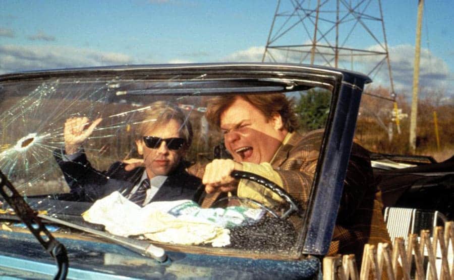 David Spade and Chris Farley driving a convertible in a scene from Tommy Boy 