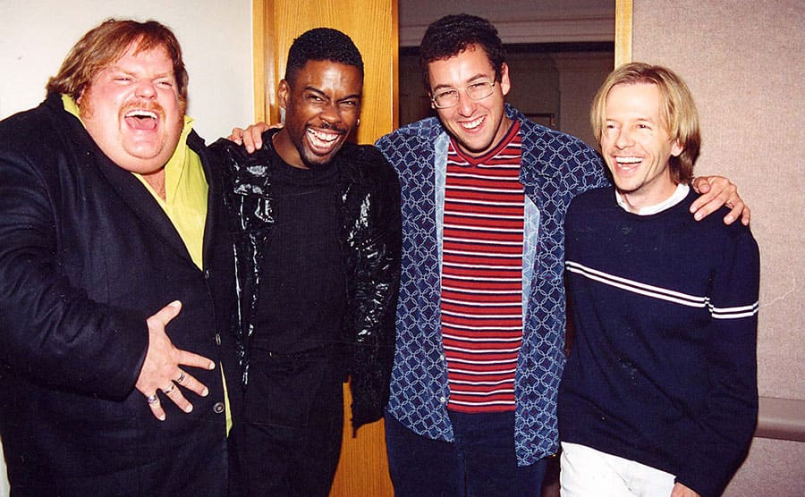 Chris Farley, Chris Rock, Adam Sandler, and David Spade laughing together 