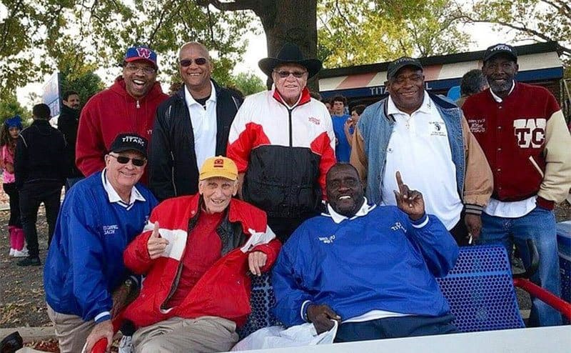 Julius Campbell, seated front right, and former ’71 Titans teammates pose with coaches Bill Yoast, seated at left, and Herman Boone, standing center, at the 50th anniversary celebration of T.C. Williams High School in 2015.