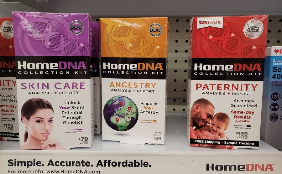 Close-up of HomeDNA kits, including testing for ancestry, skincare, and paternity, on a pharmacy shelf.
