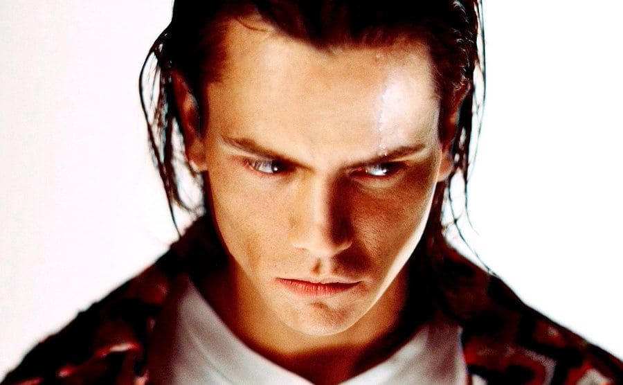 River Phoenix poses at a photo shoot in a studio in Los Angeles, California.